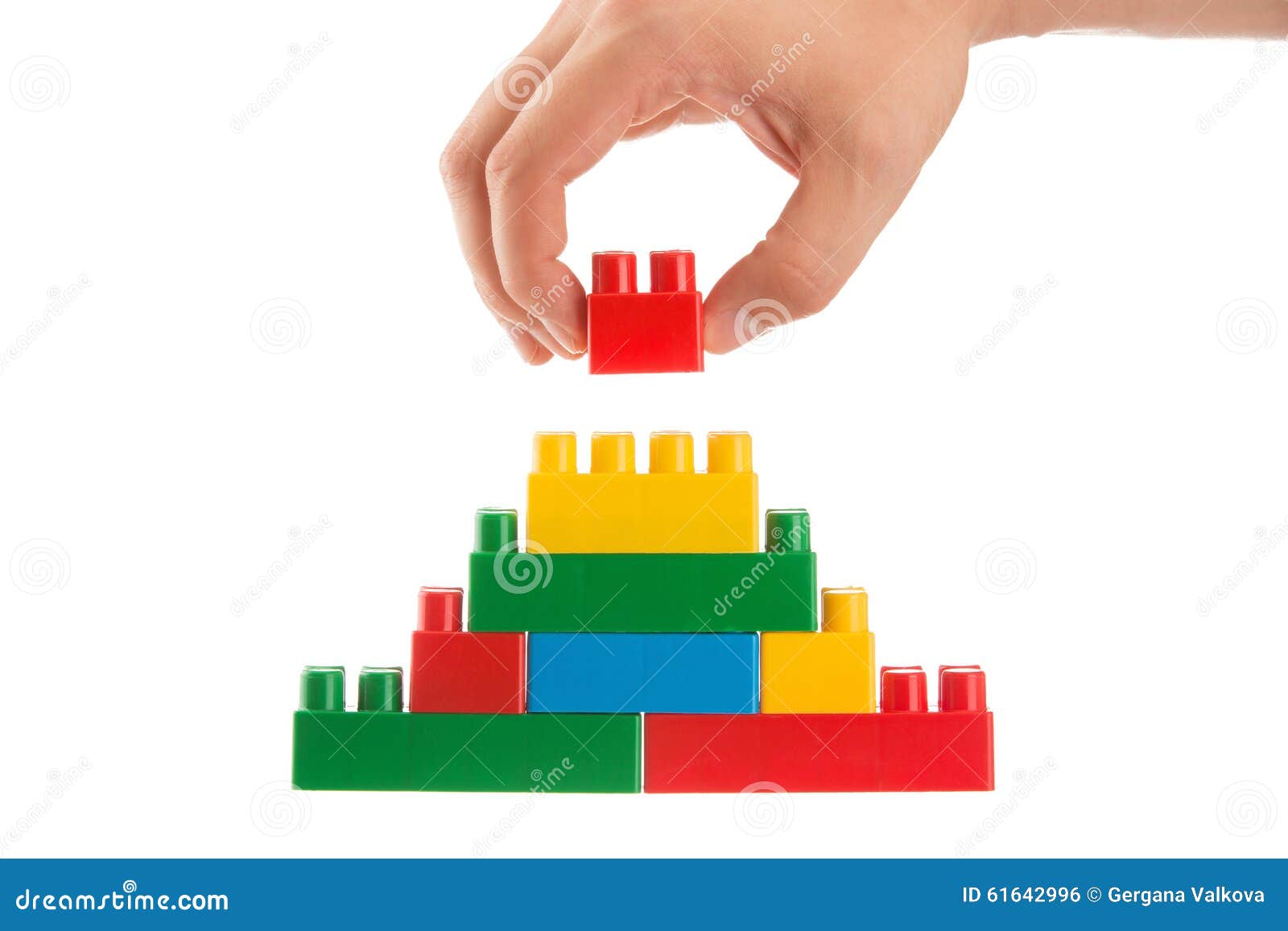 hand building up a wall by stacking up lego, business conception