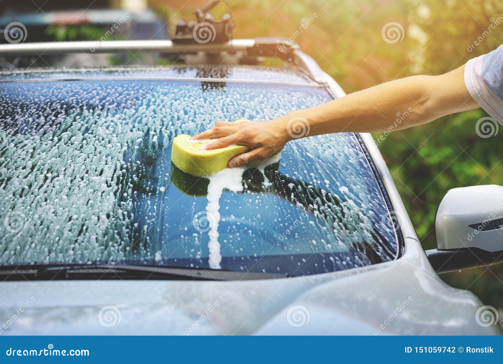 hand car wash - washing windshield with sponge