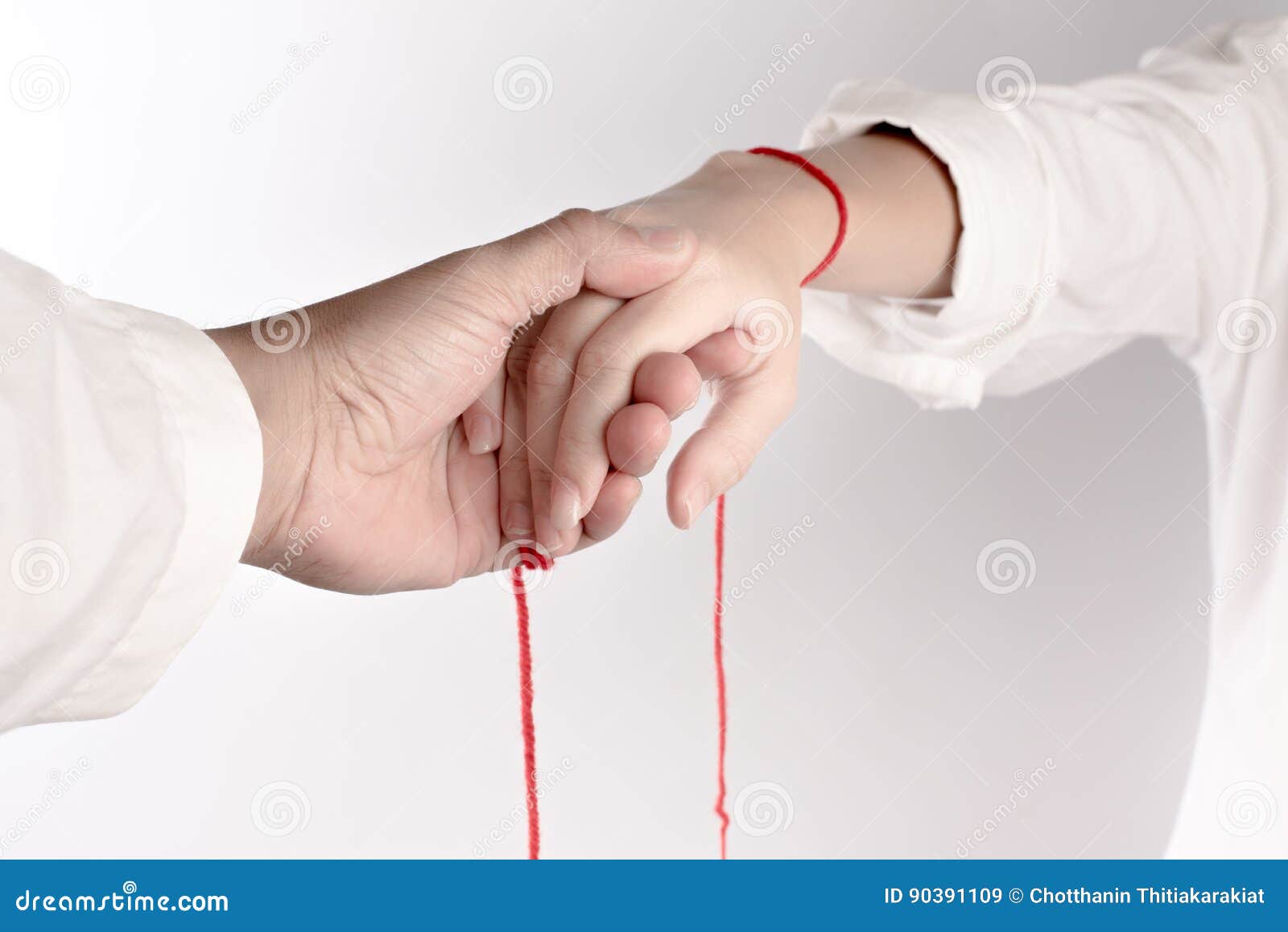 a hand of couple touch each other. the faith of red thread brings destiny
