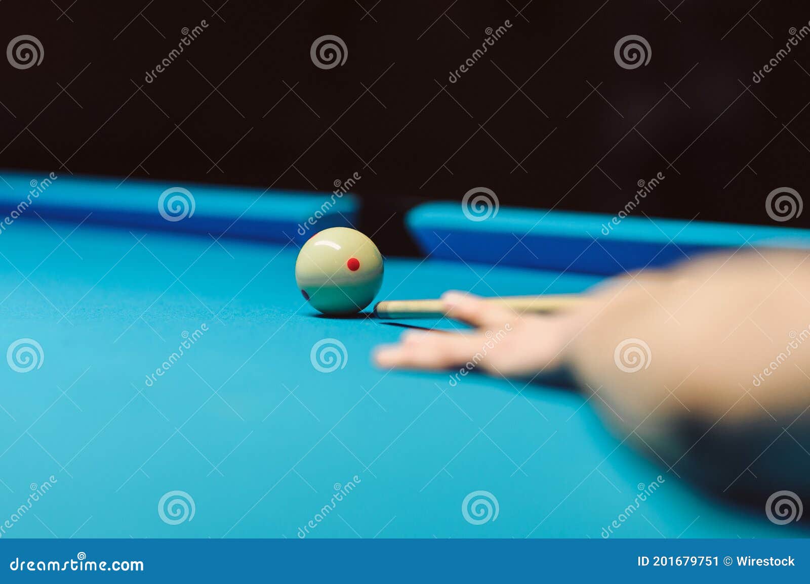 Hand with Cue Stick on Blue Billiard Table with Ball Stock Image