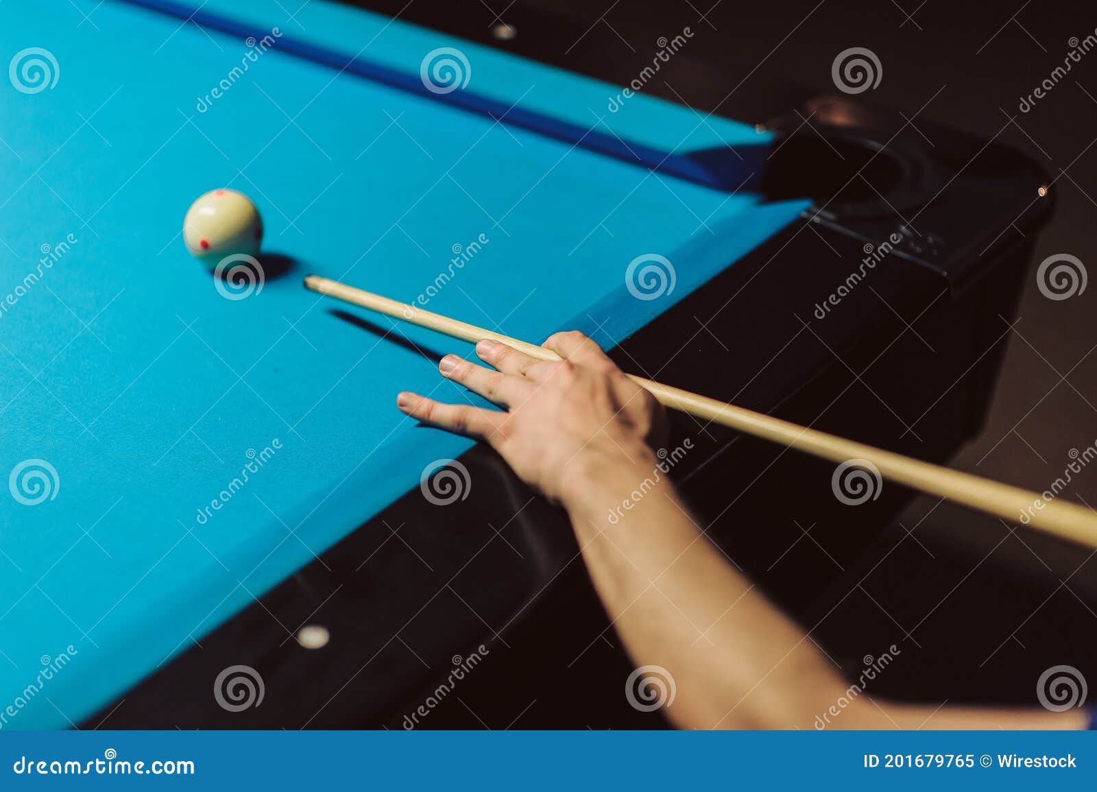 Hand with Cue Stick on Blue Billiard Table with Ball Stock Image