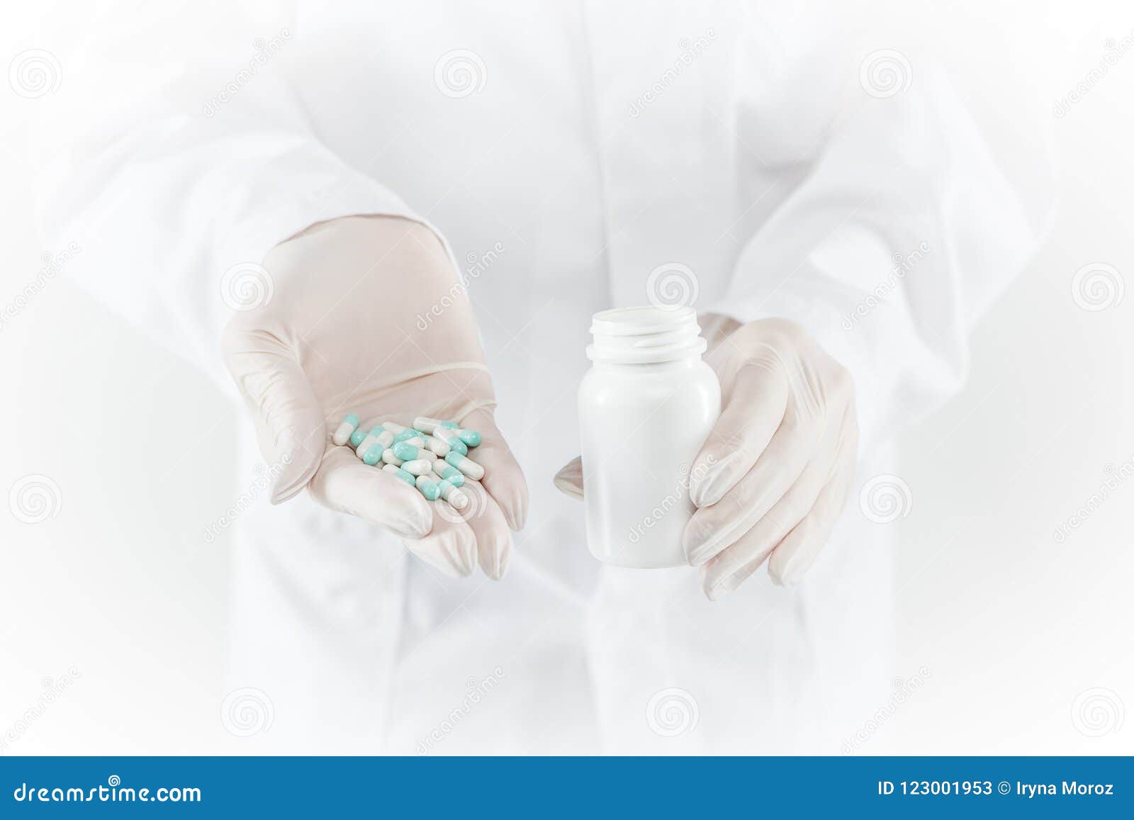 Hand Of Doctor Holding Medicine Bottle On Medicine Cabinet Stock