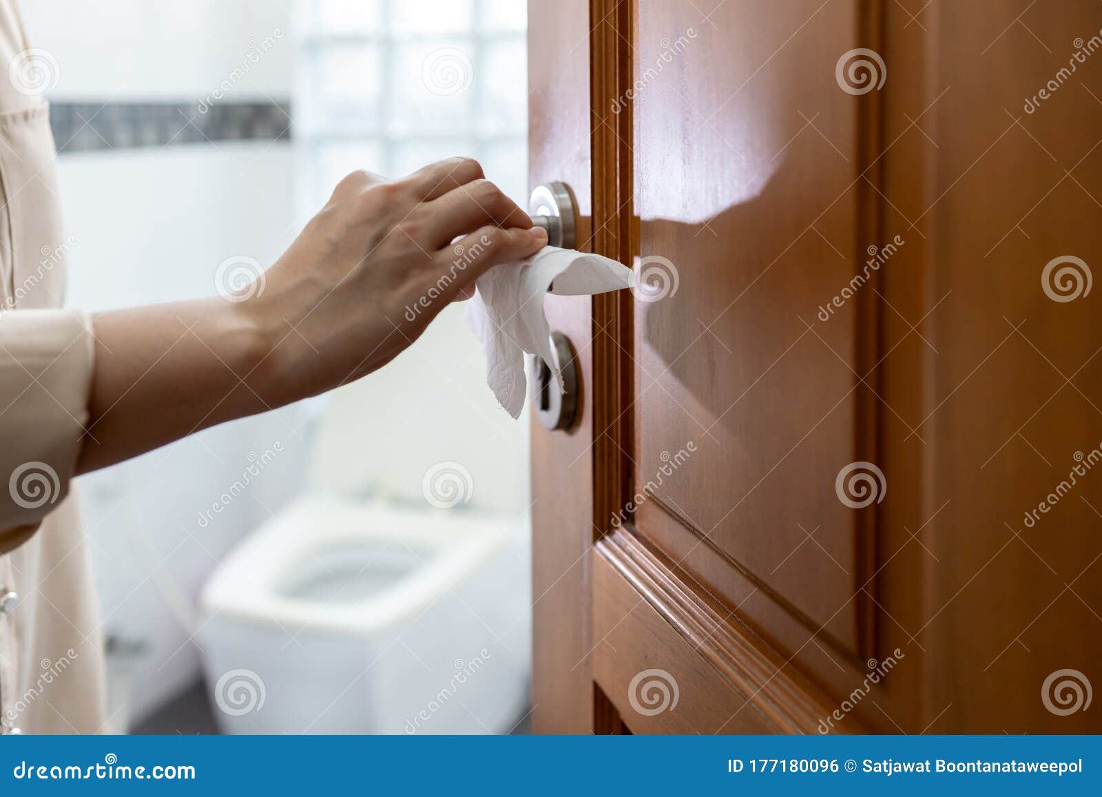 hand with door handle,girl open the bathroom door,woman using tissue paper to touch the door knob instead of hands to prevent