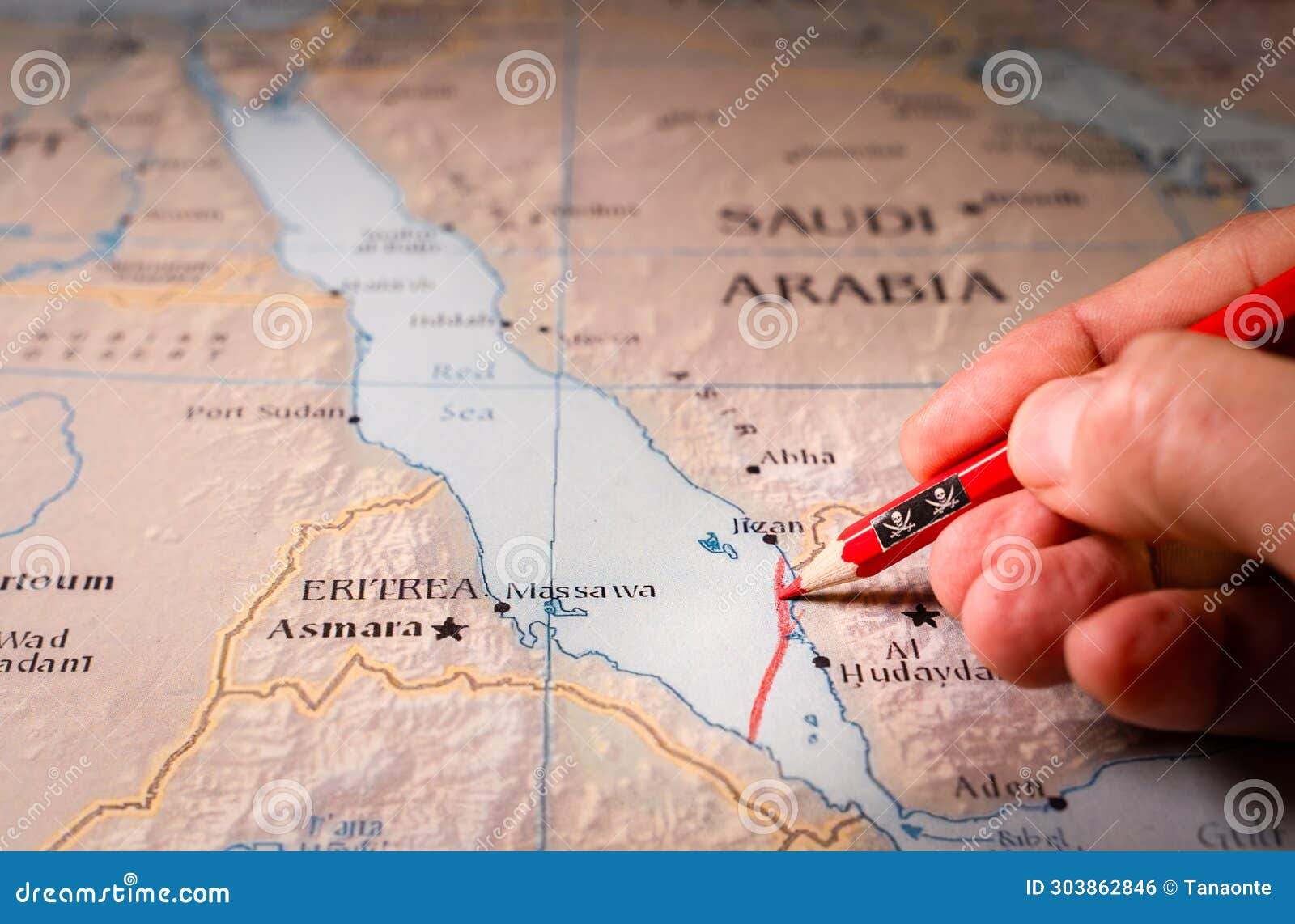 hand drawing a red line and closing the maritime passage through the red sea.