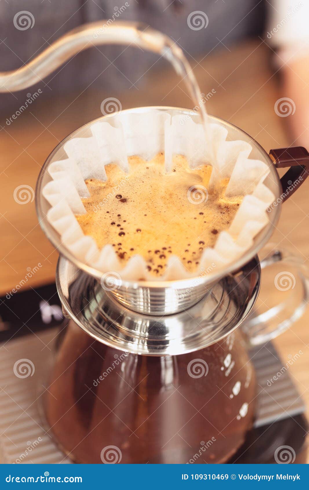 hand drip coffee, barista pouring water on coffee ground with filter