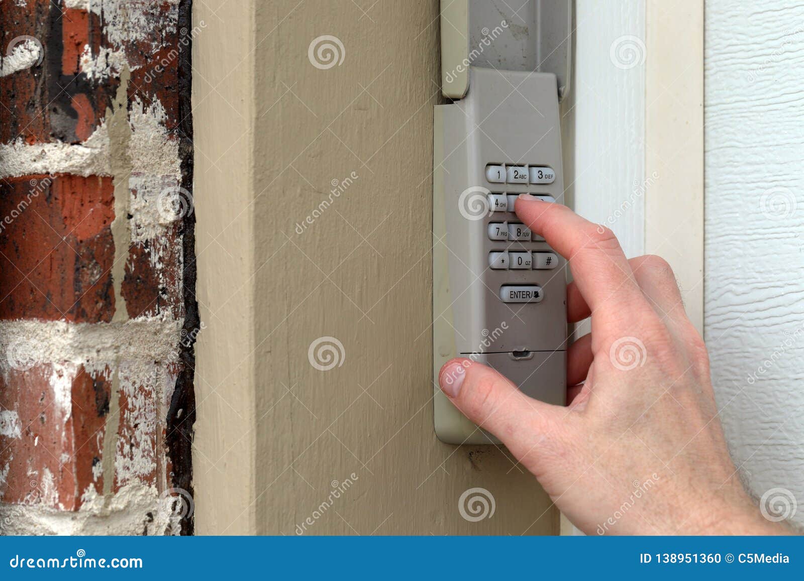 Hand Entering Code On Keypad Garage Door Opener Home Security
