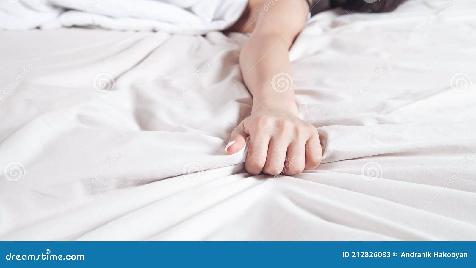 Hand of Female Pulling White Sheets