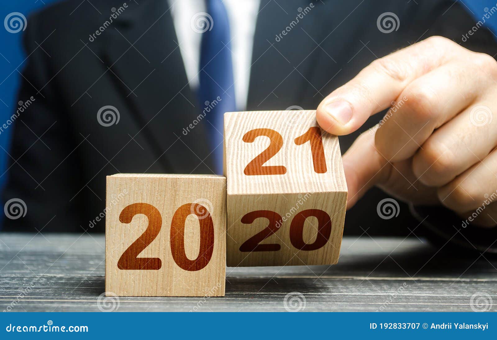 hand flips a block changing 2020 to 2021. new year beginning. holidays and christmas. trends and changes in the world. summing