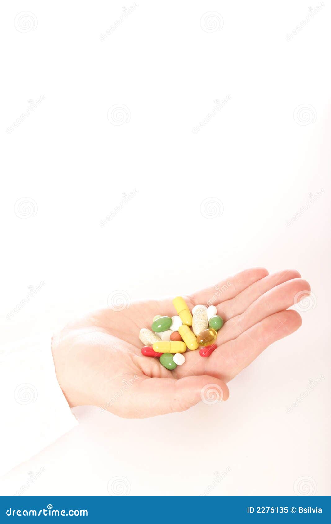 Woman with a hand full of pills