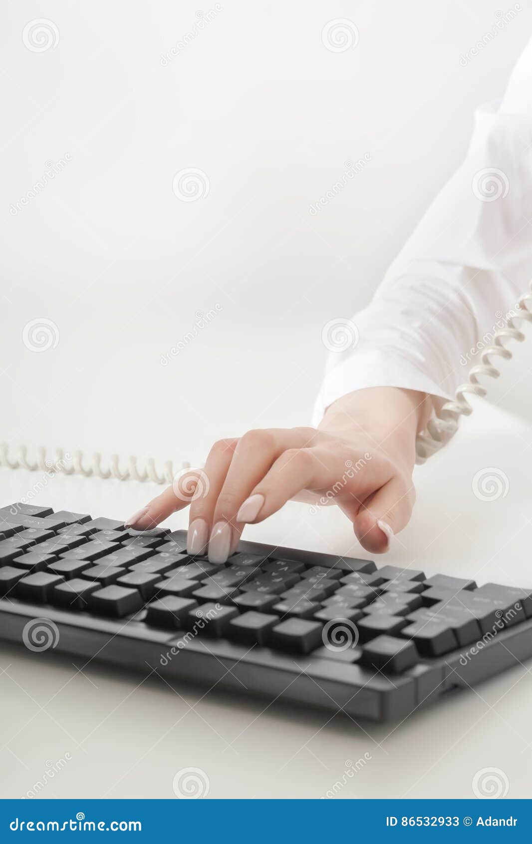 Man`s Hand Are Keying Information From Smartphone Into Laptop. Identity Verification Code Stock