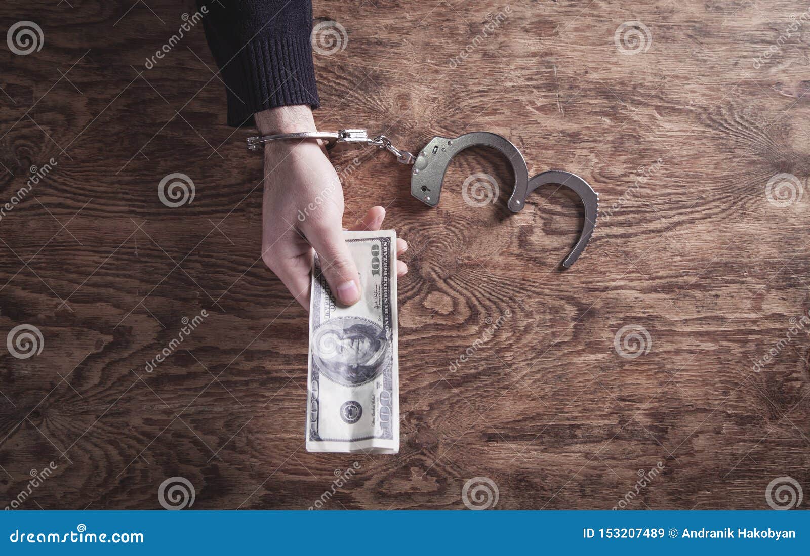 Hand in Handcuffs Holding Dollar Banknotes. Corruption Stock Image