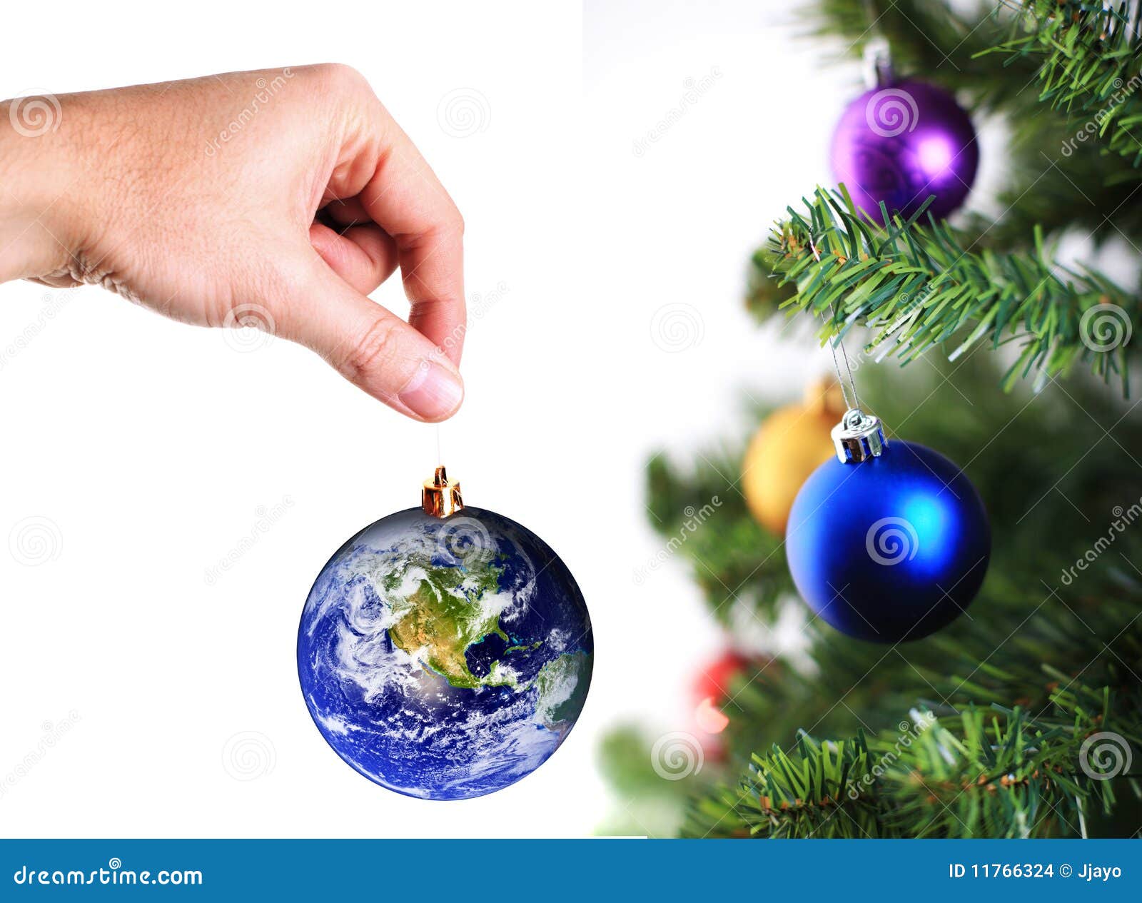 Hand Hanging Up Earth Decoration on Christmas Tree Stock Photo Image