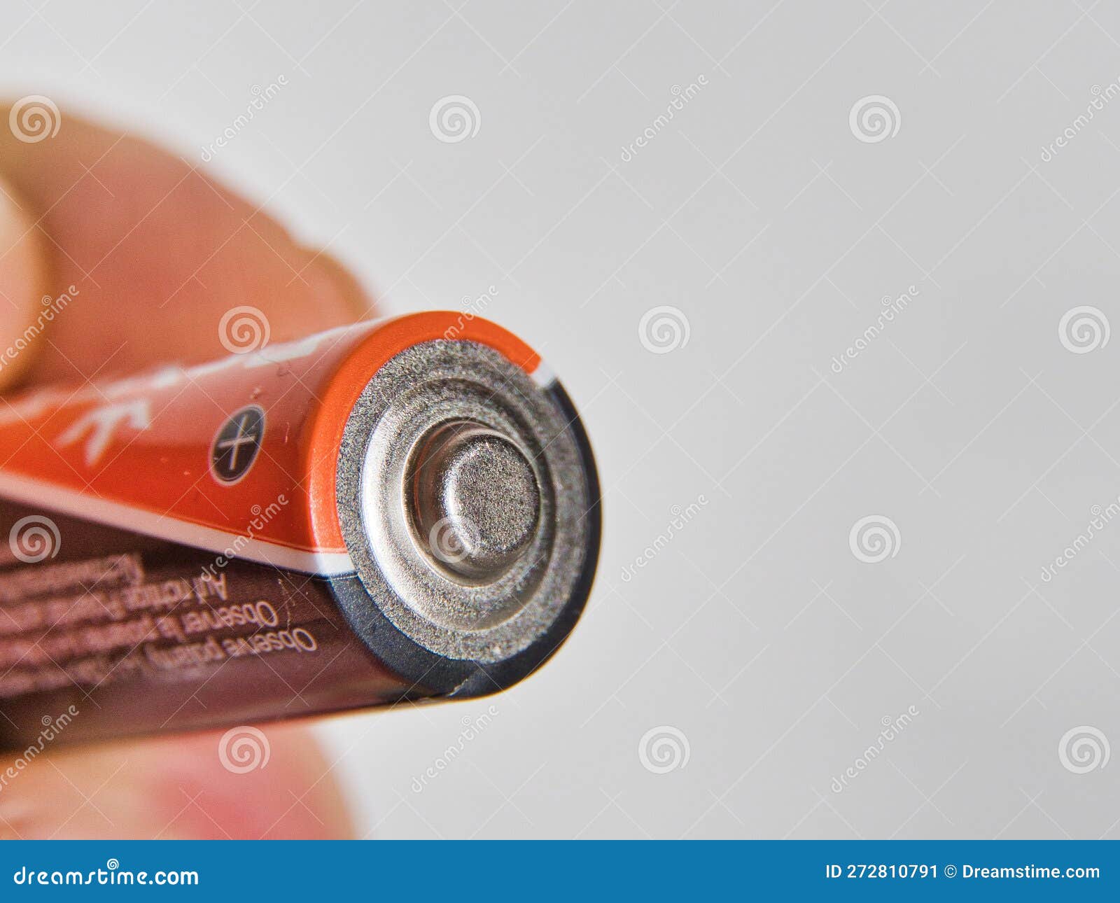 Hand Holding AA Batterie, Isolated on White Background Stock Image