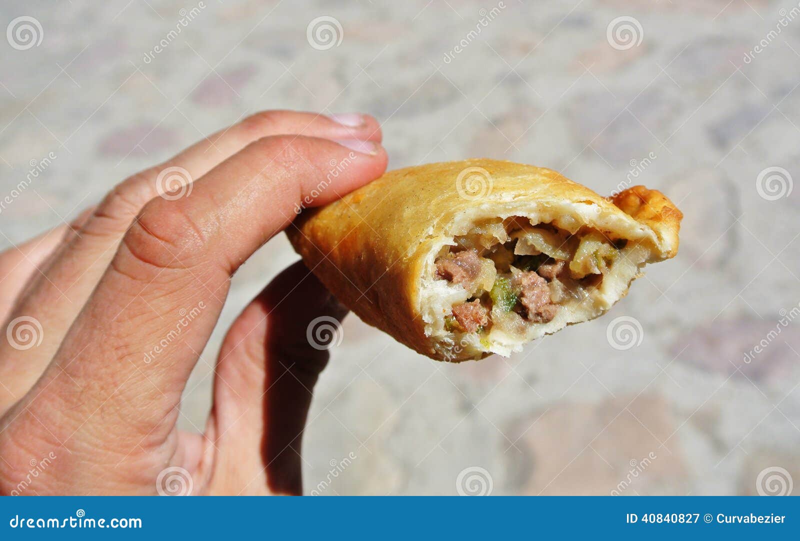 hand holding an argentinean empanada