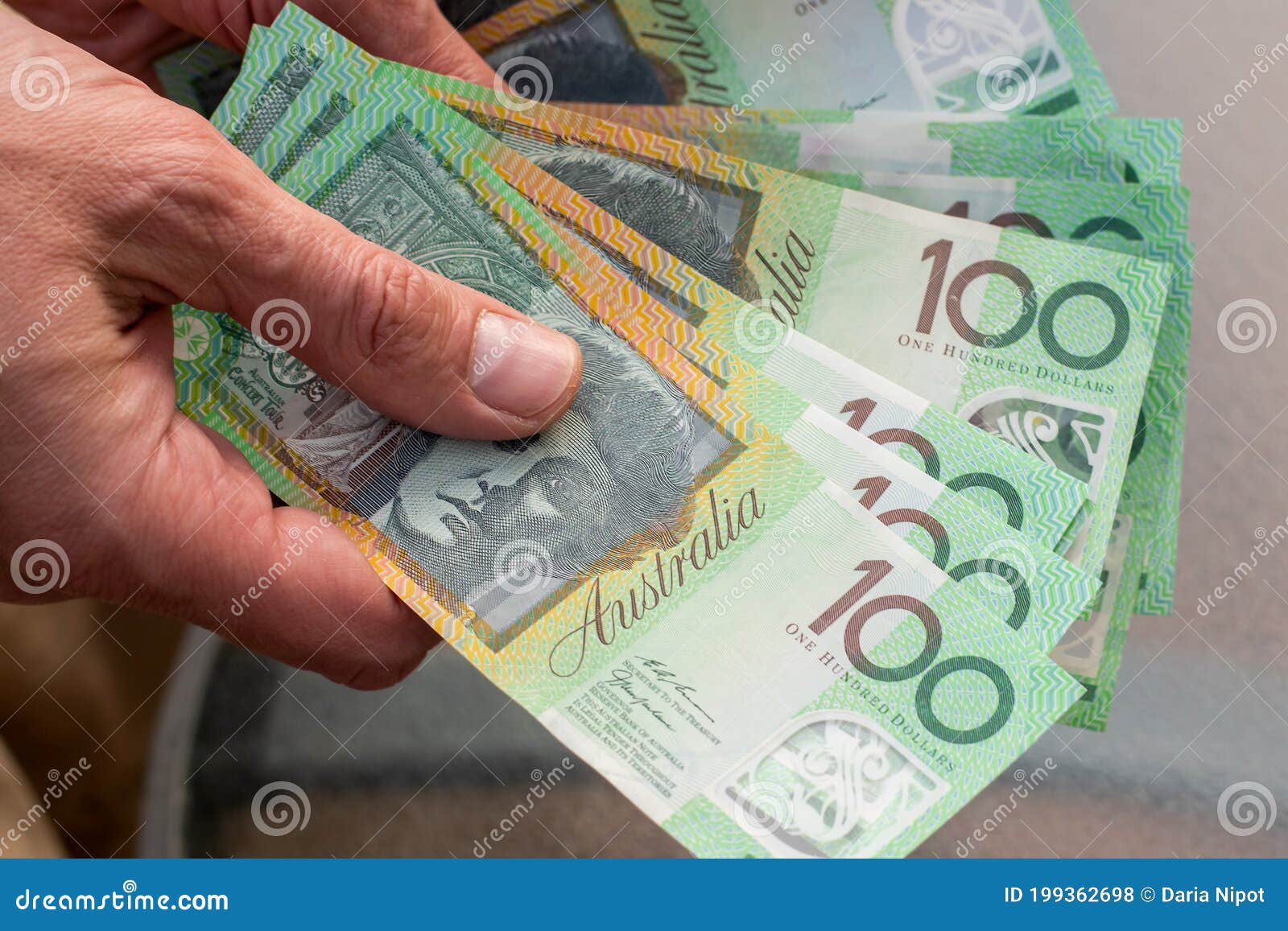 Hand Holding Australian 100 Banknotes on Glass Table Background. Finance and Payment Concept Stock Photo - Image of australian, caucasian: 199362698