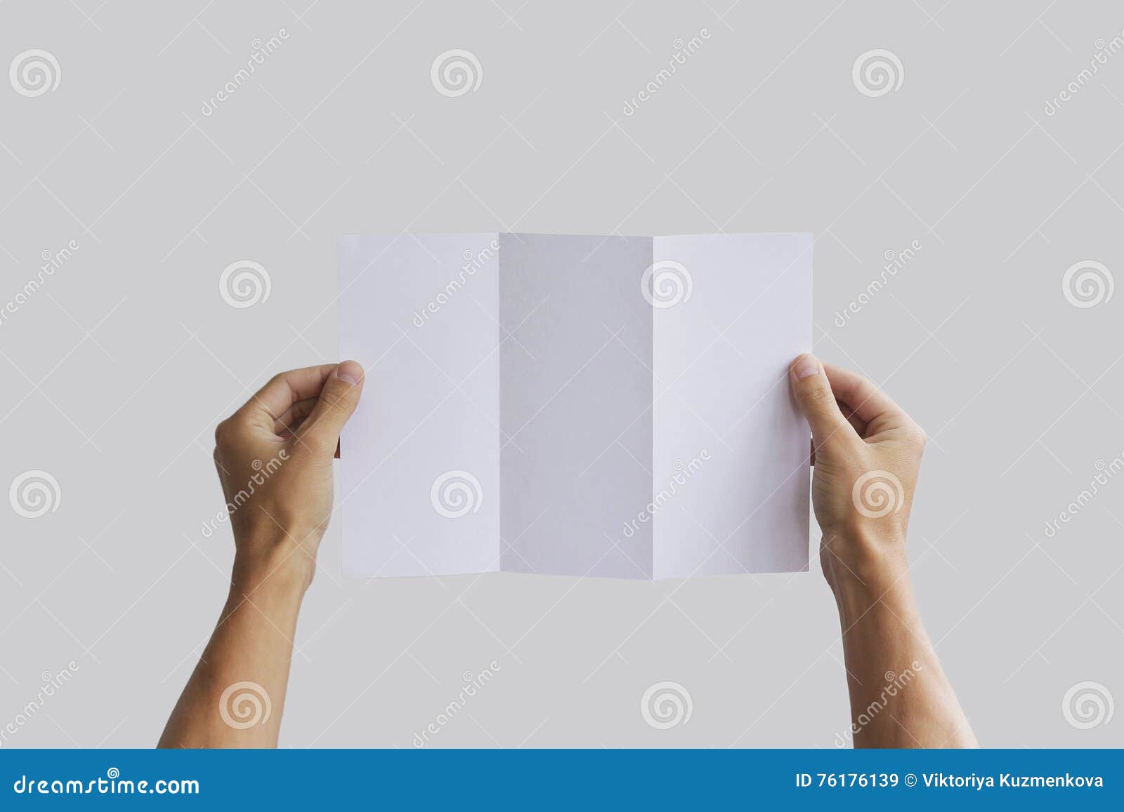 hand holding blank brochure booklet in the hand leaflet