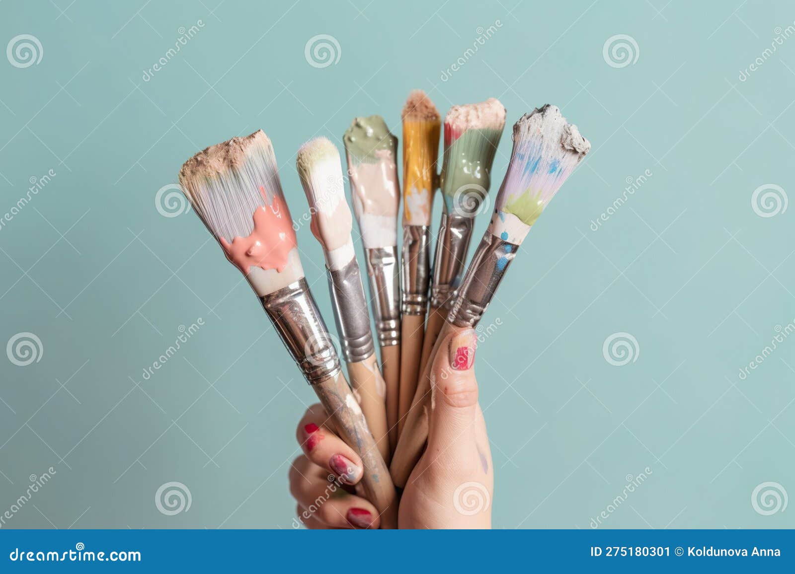 Hand Holding a Bouquet of Paint Brushes and Rollers Created with