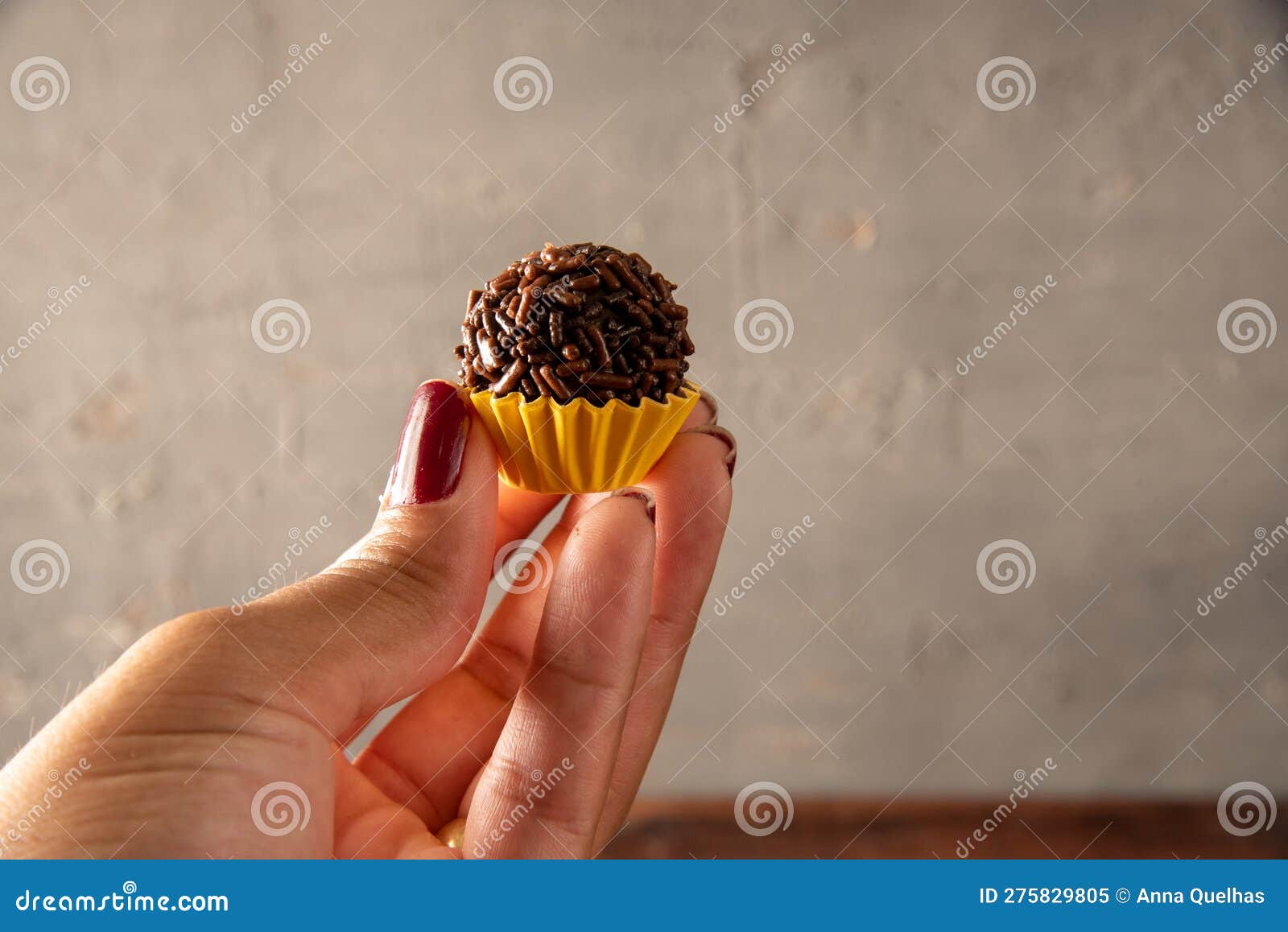 hand holding brazilian bonbon brigadeiro