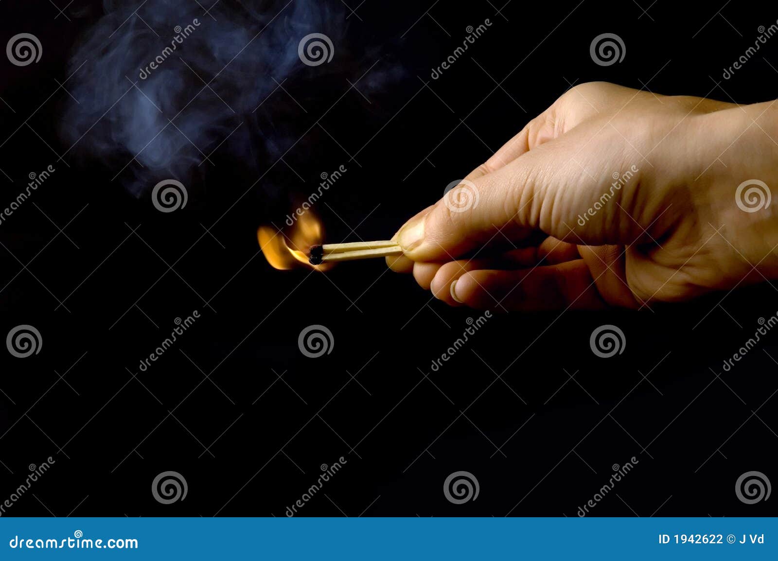 hand holding a burning match