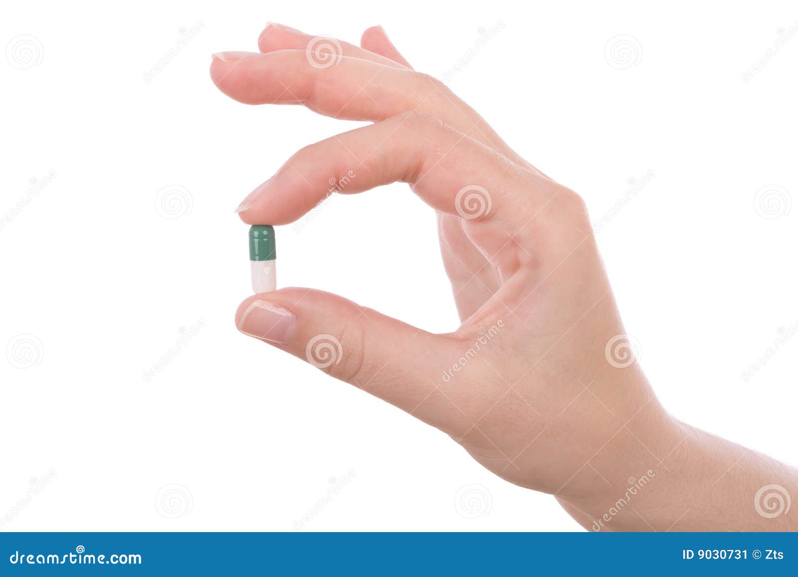 hand holding a capsule or pill