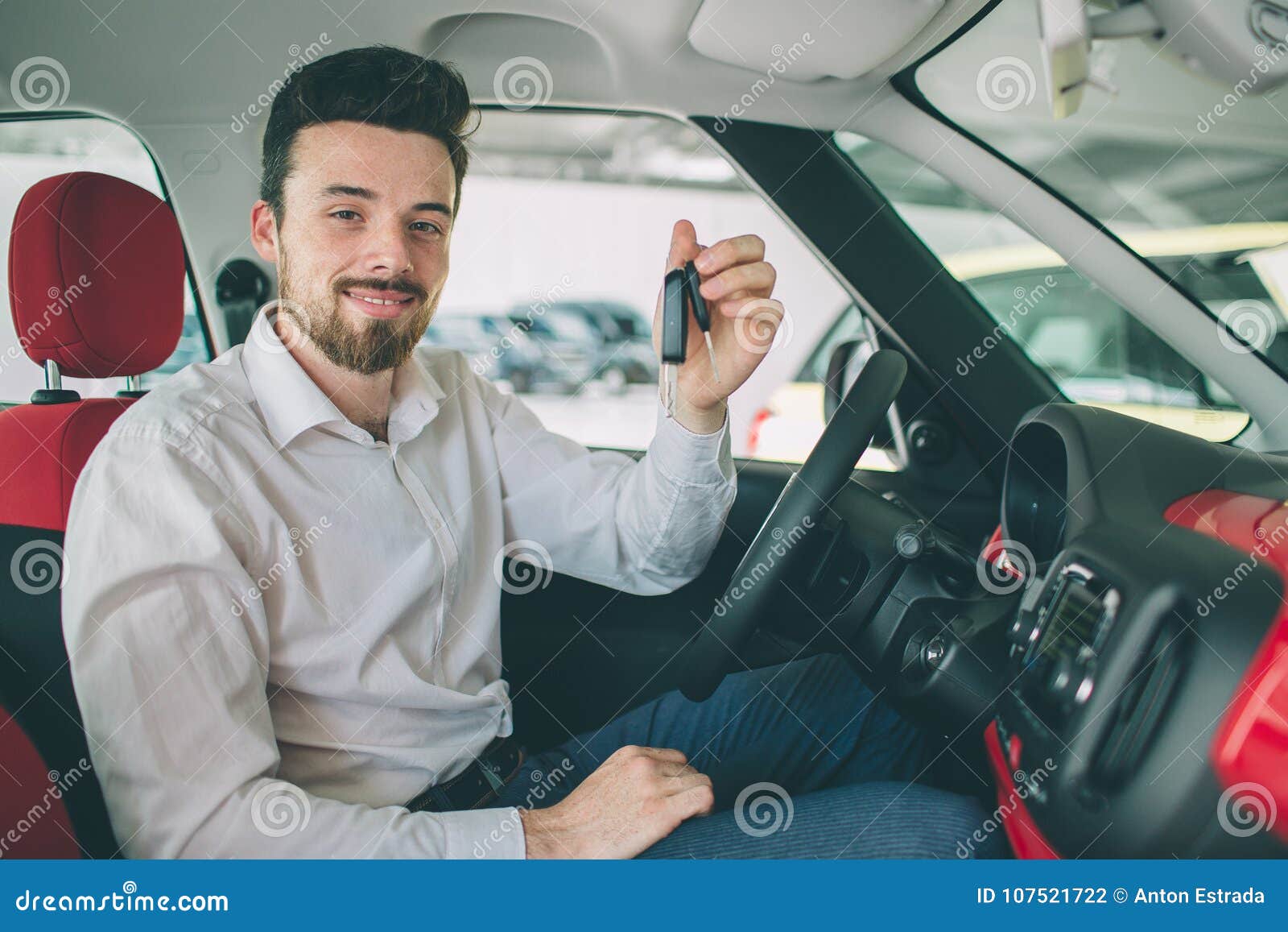 Hand Holding Car Key Remote, with Modern Car Backgrounds. Man Sitting  Inside New Car with Keys. Stock Photo - Image of agent, lock: 107521722