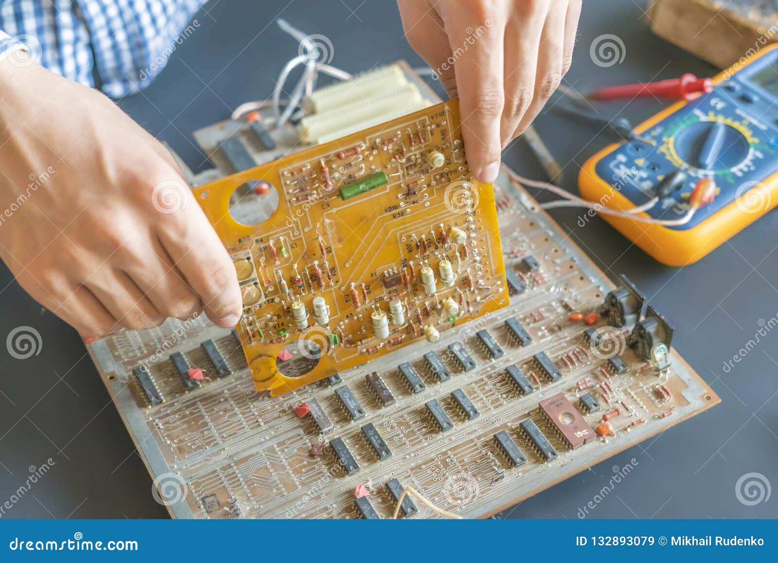 Hand Holding an Electric Circuit Board Repair Fix and Assemble Electronics Concept F Stock Image