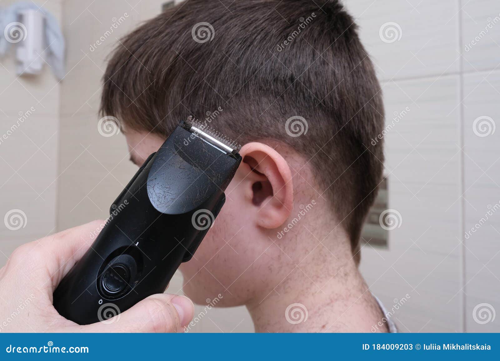 A Hand Holding Electric Hair Clipper and Going To Make a Boy Haircut at Home  in the Bathroom, Homemade Hairstyle Stock Image - Image of hairstyle, hair:  184009203
