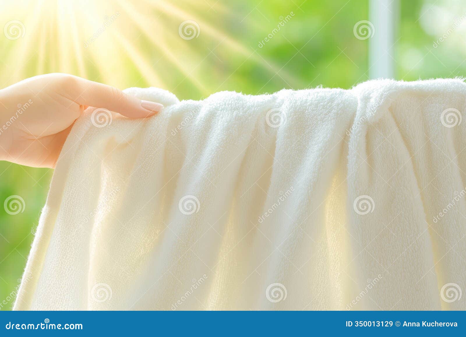 hand holding a fluffy white towel in bright sunlight