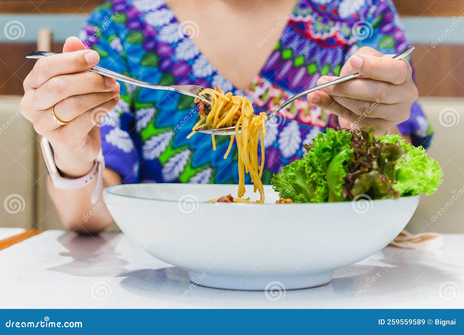 Hand Holding Fork and Spoon Eating Spaghetti. Stock Image Image of