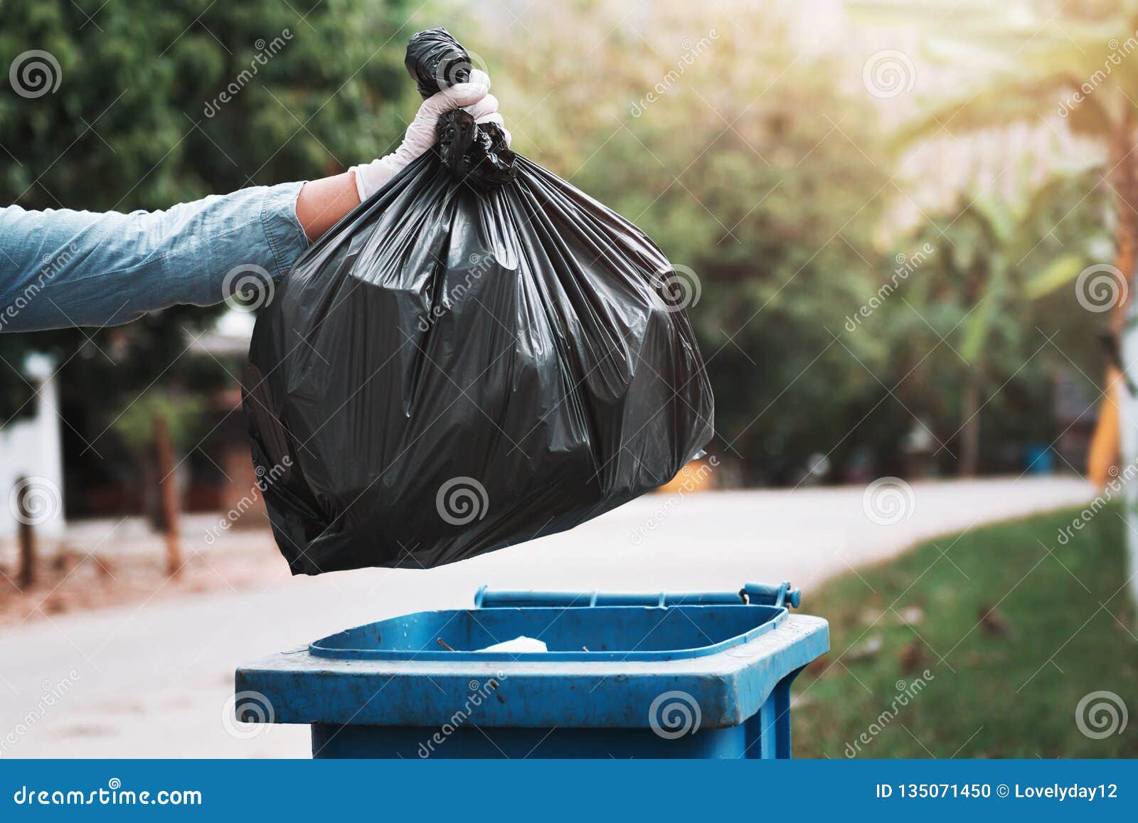 Hand Holding Garbage Bag Putting in To Trash Stock Photo Image of grass, male 135071450