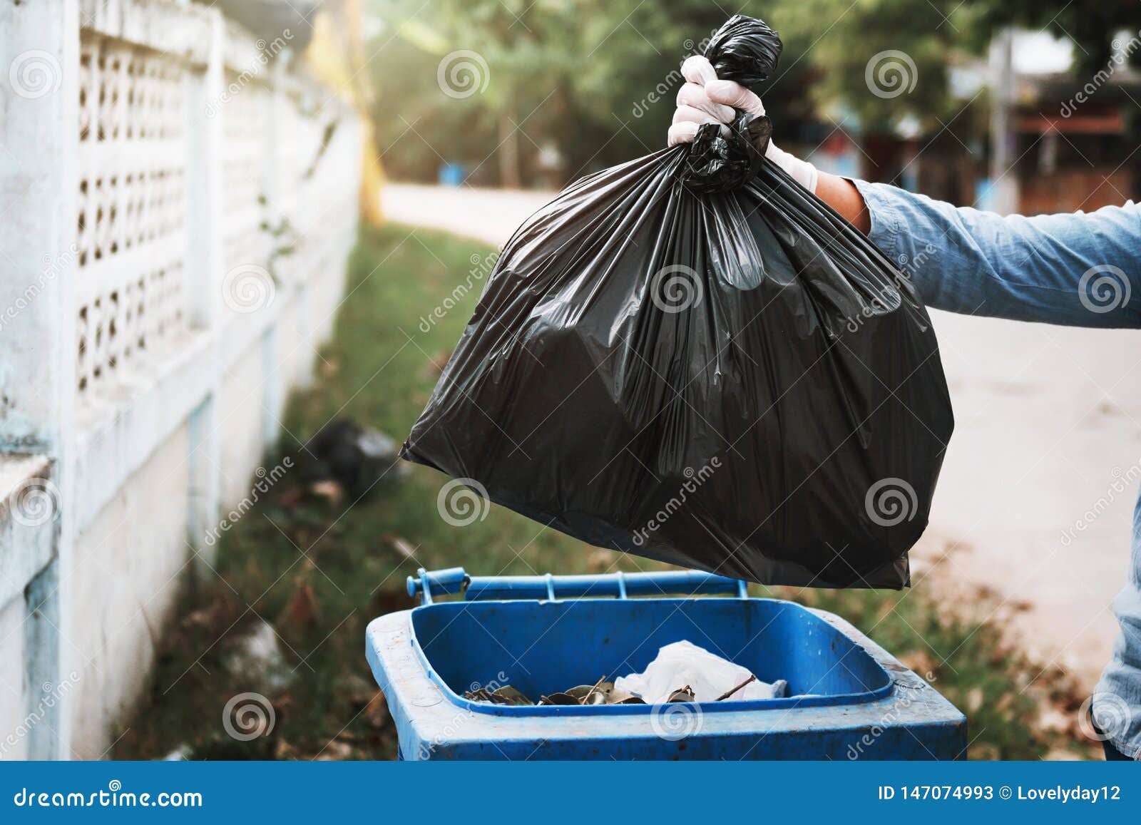 Hand holding trash bag Stock Photo by ©Pupkis 63579871