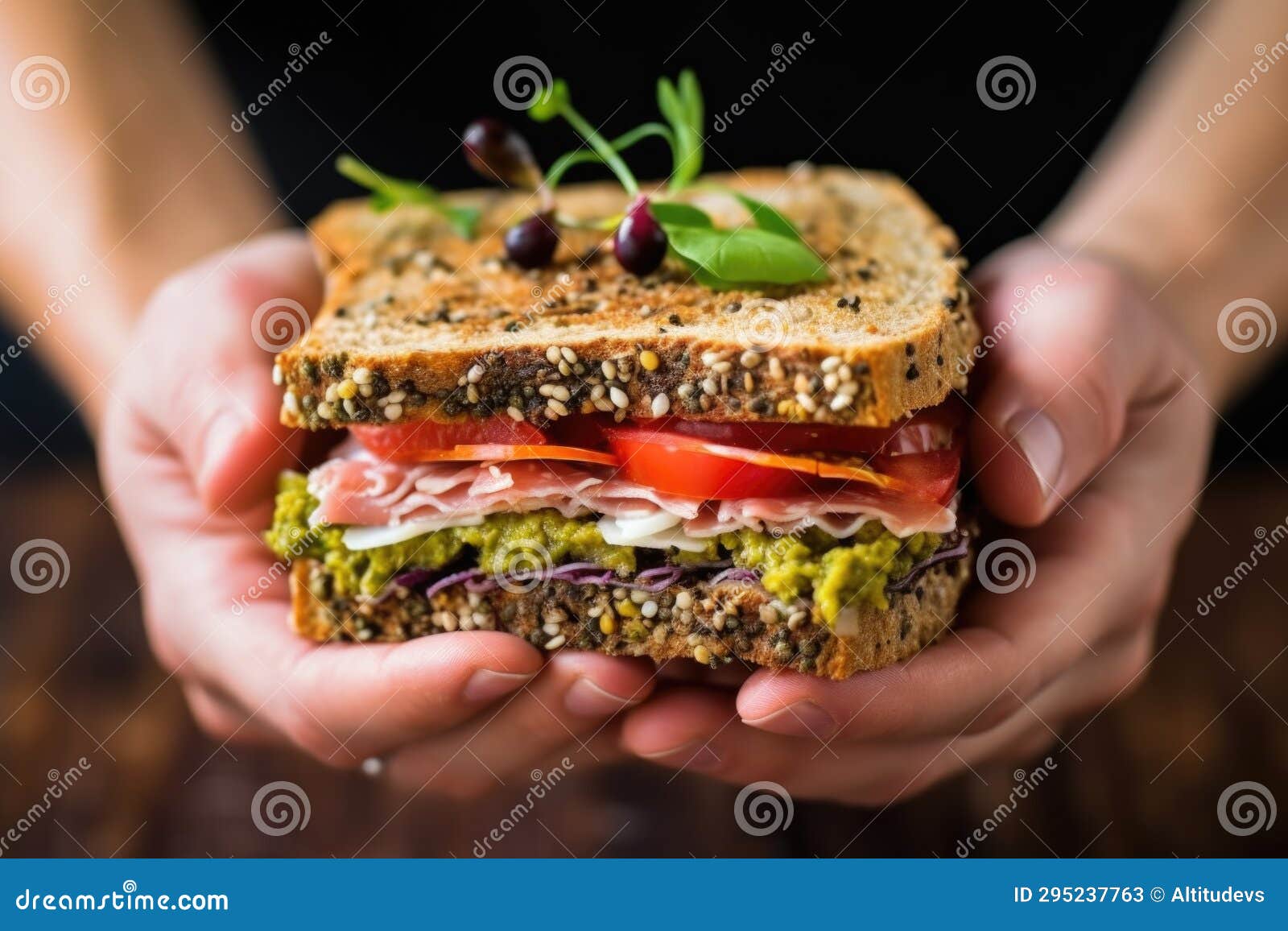Hand Holding a Gourmet Sandwich with Tapenade and Ham Stock Image