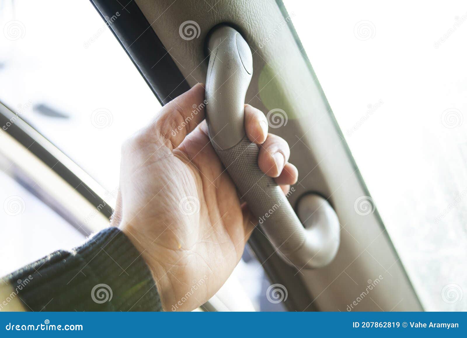 Hand Holding on Gripping Handle in Passenger Room of a Car Stock Image