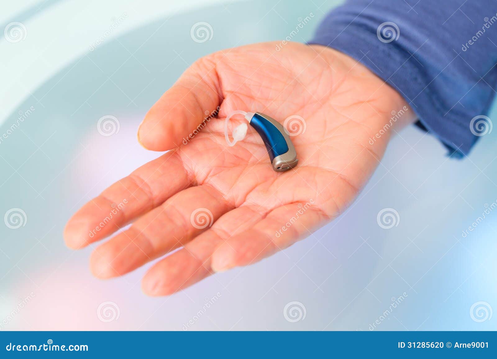 hand holding hearing aid