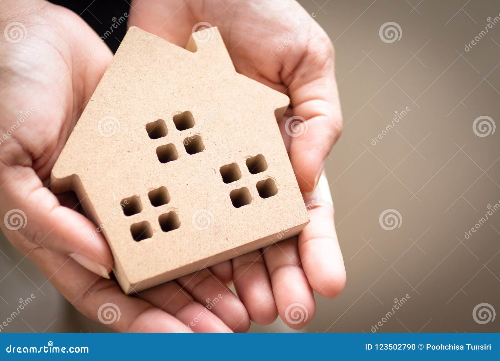 hand holding home model, happy homes for families