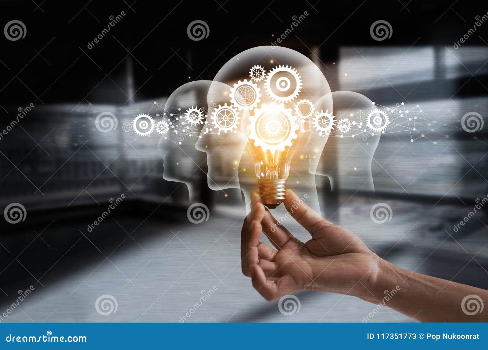 hand holding light bulb and cog inside. idea and imagination.