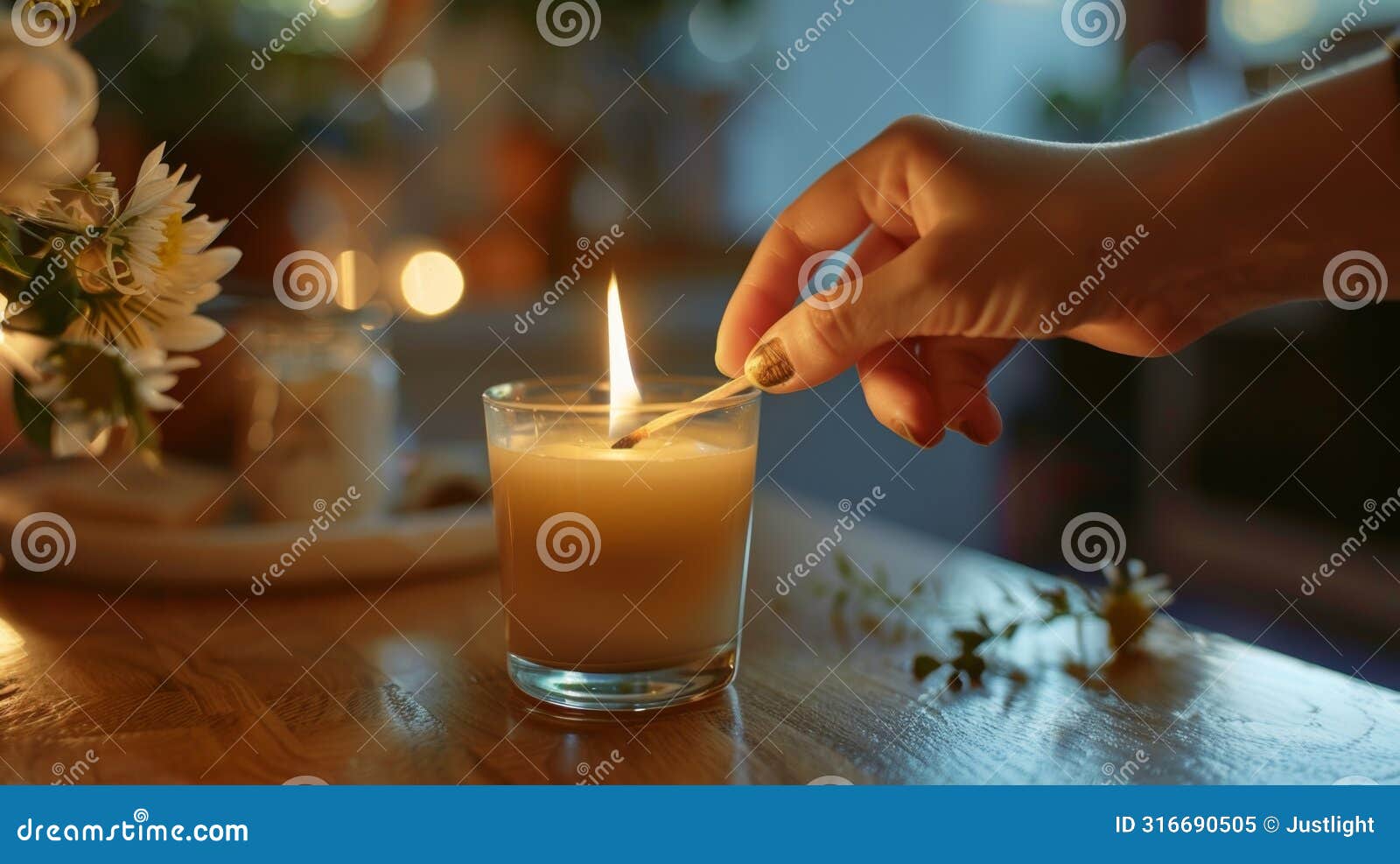 a hand holding a match ready to light the candles and start an evening of relaxation indulgence and selfcare