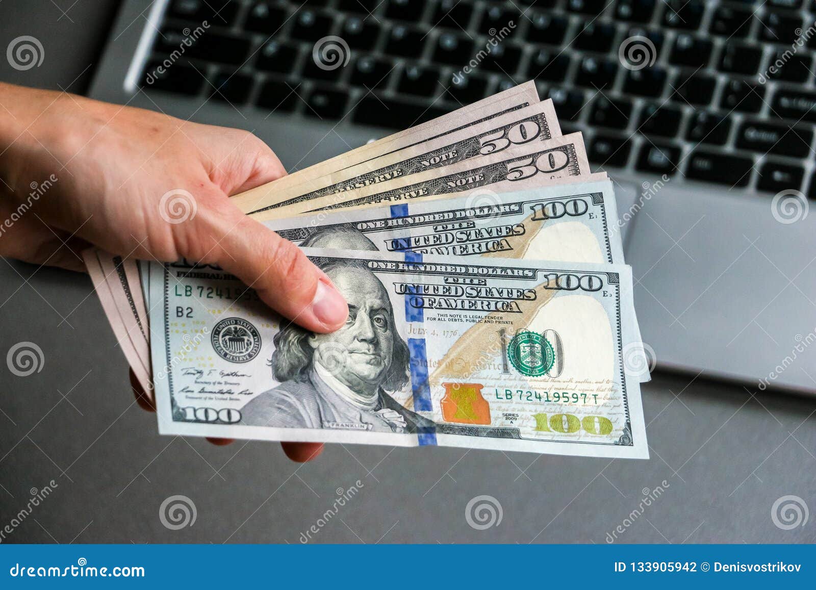 Hand Holding One Hundred and Fifty Dollar Banknotes Stock Photo 