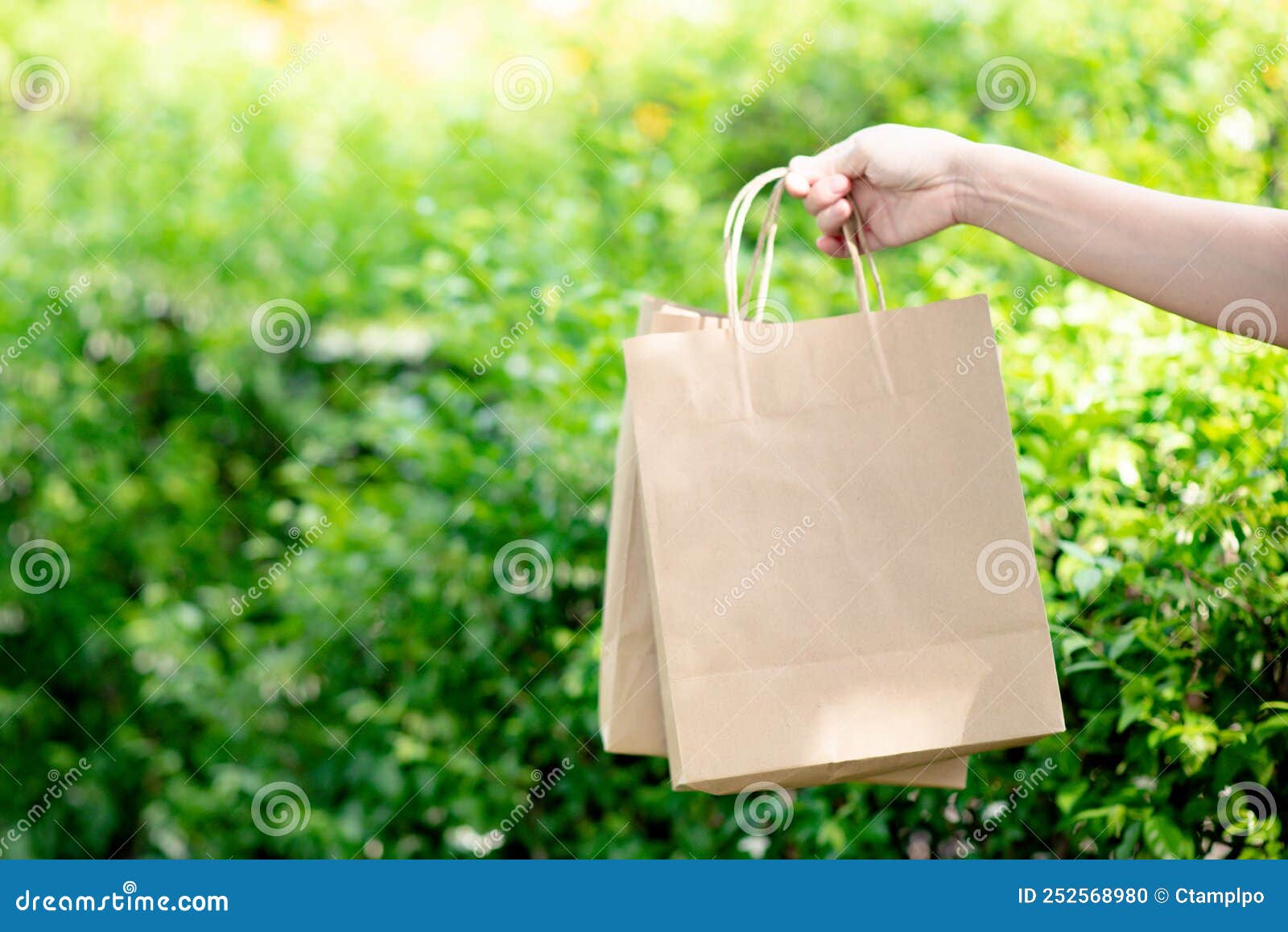 Hand Holding Paper Bags that are Environmentally Friendly Stock Photo