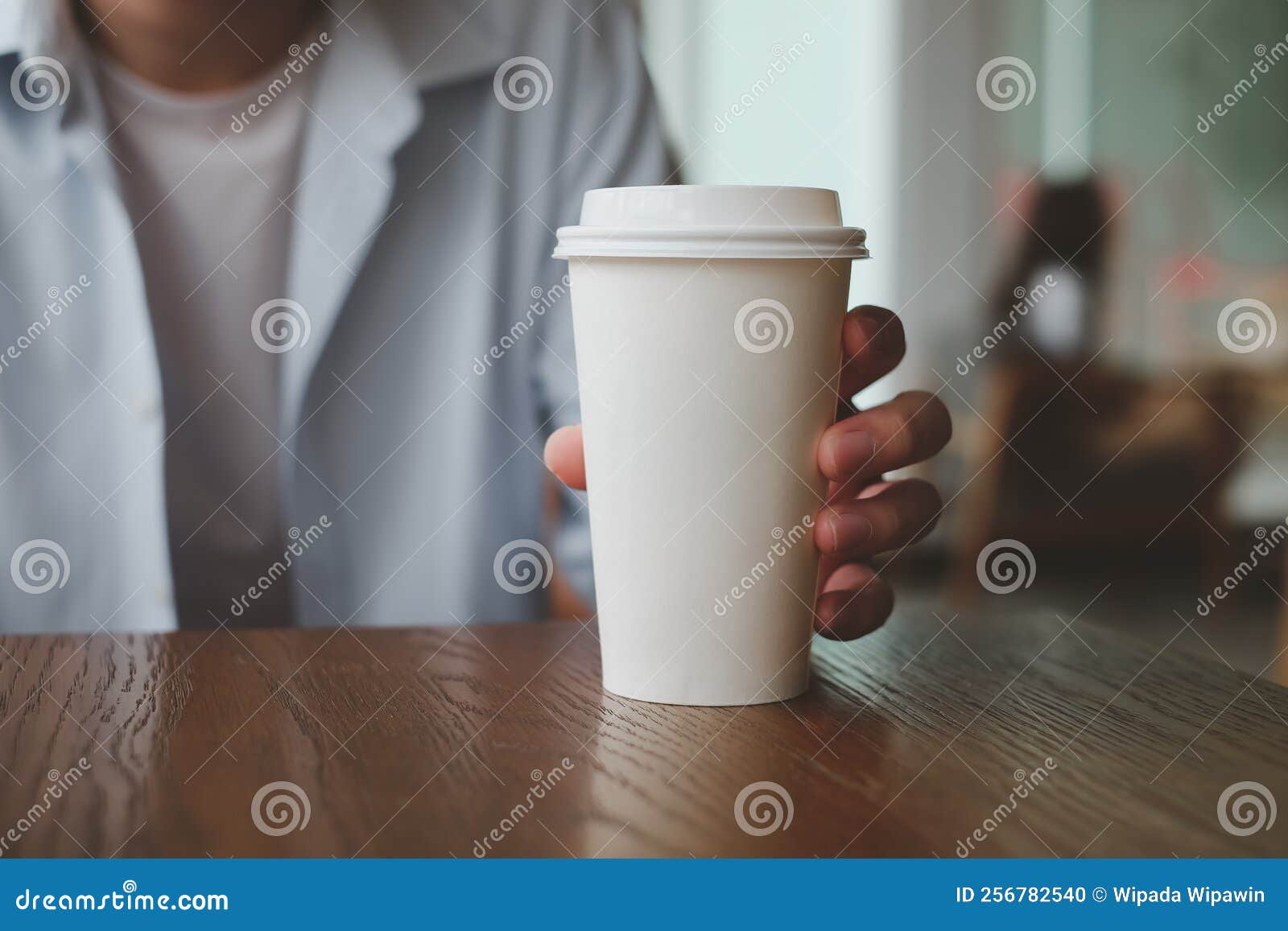 Hand Holding Paper Cup of Hot Coffee in Cafe. Stock Photo Image of