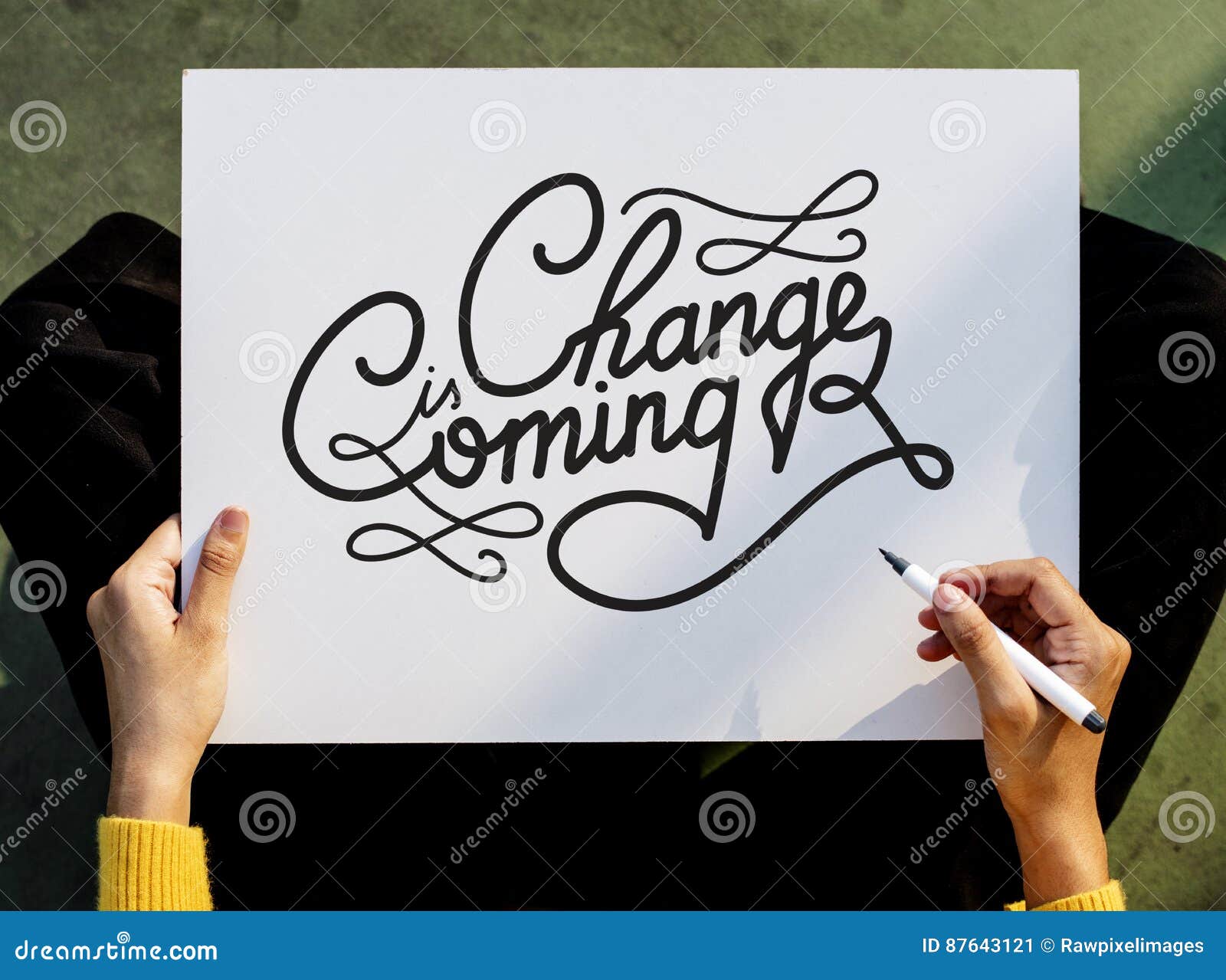 hand holding pen paper writing change is coming board concept
