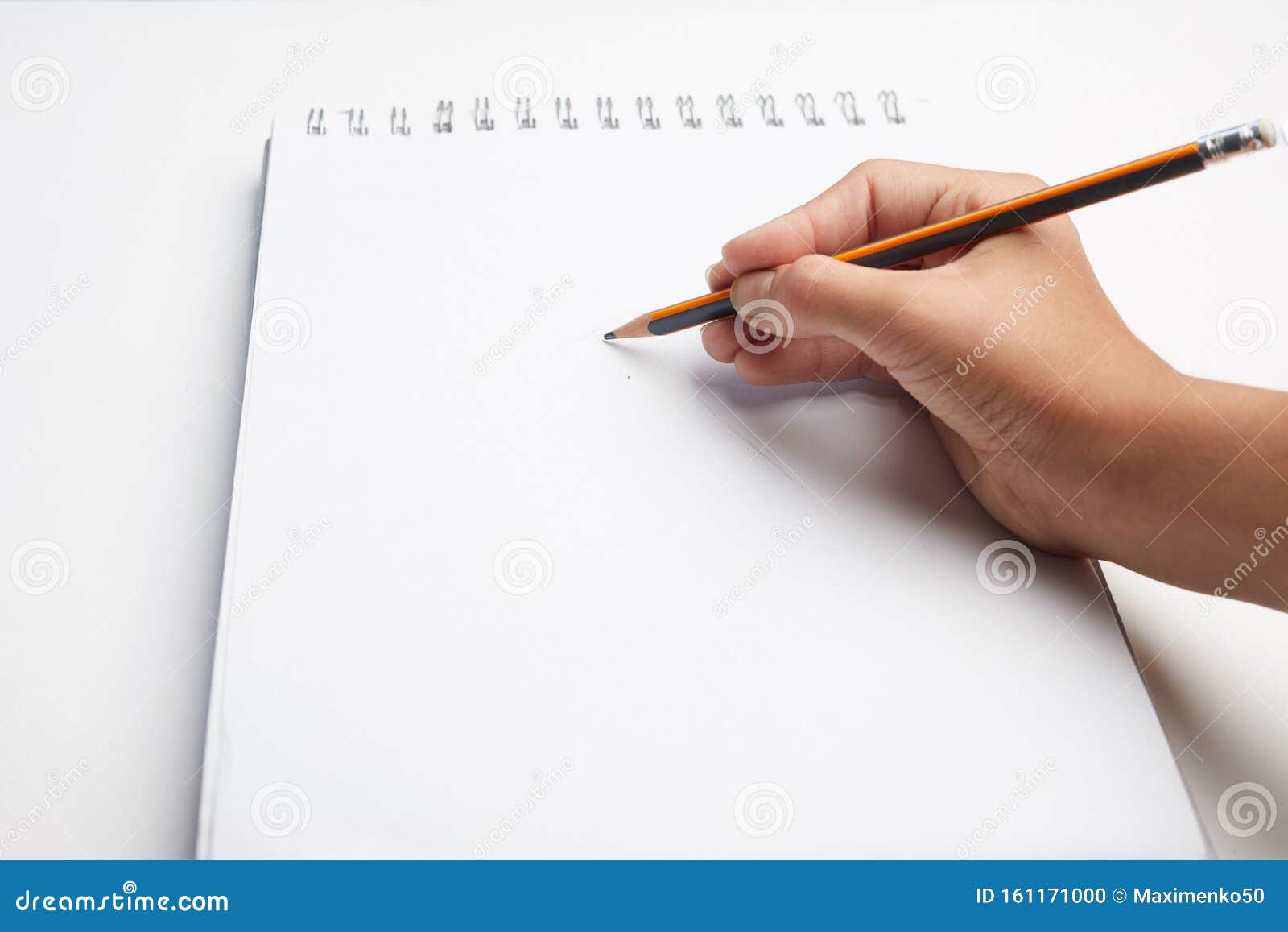 Hand Holding Pen Writing On Blank White Paper. Hand Write In The