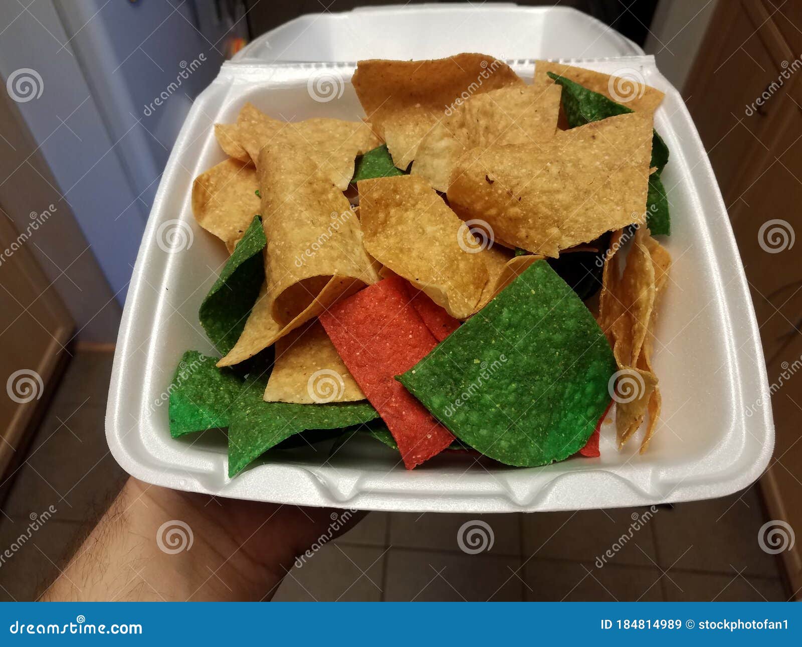 Hand Holding Plain and Red and Green Tortilla Chips Stock Image Image