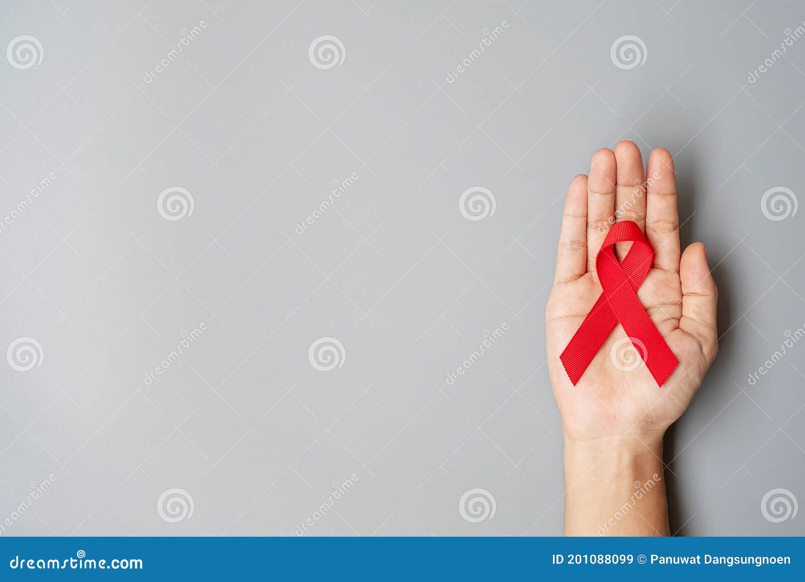 Hand Holding Red Ribbon For Supporting People Living And Illness