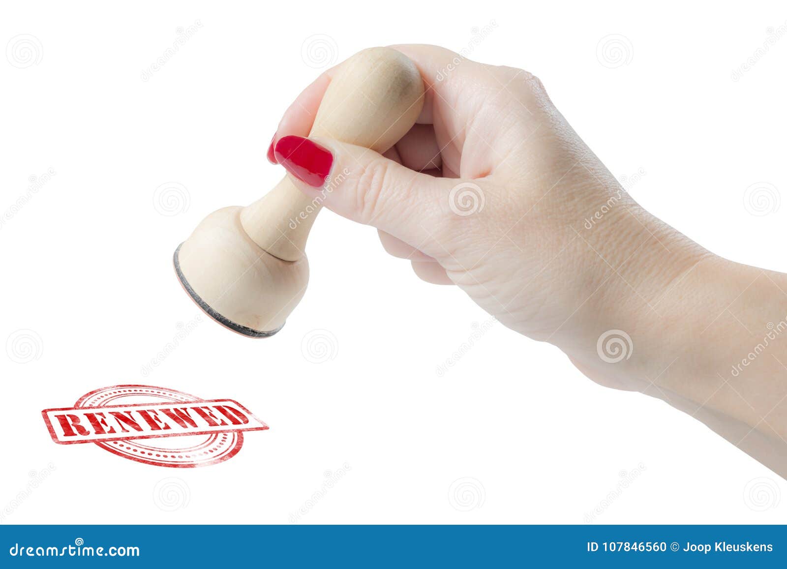 hand holding a rubber stamp with the word renewed