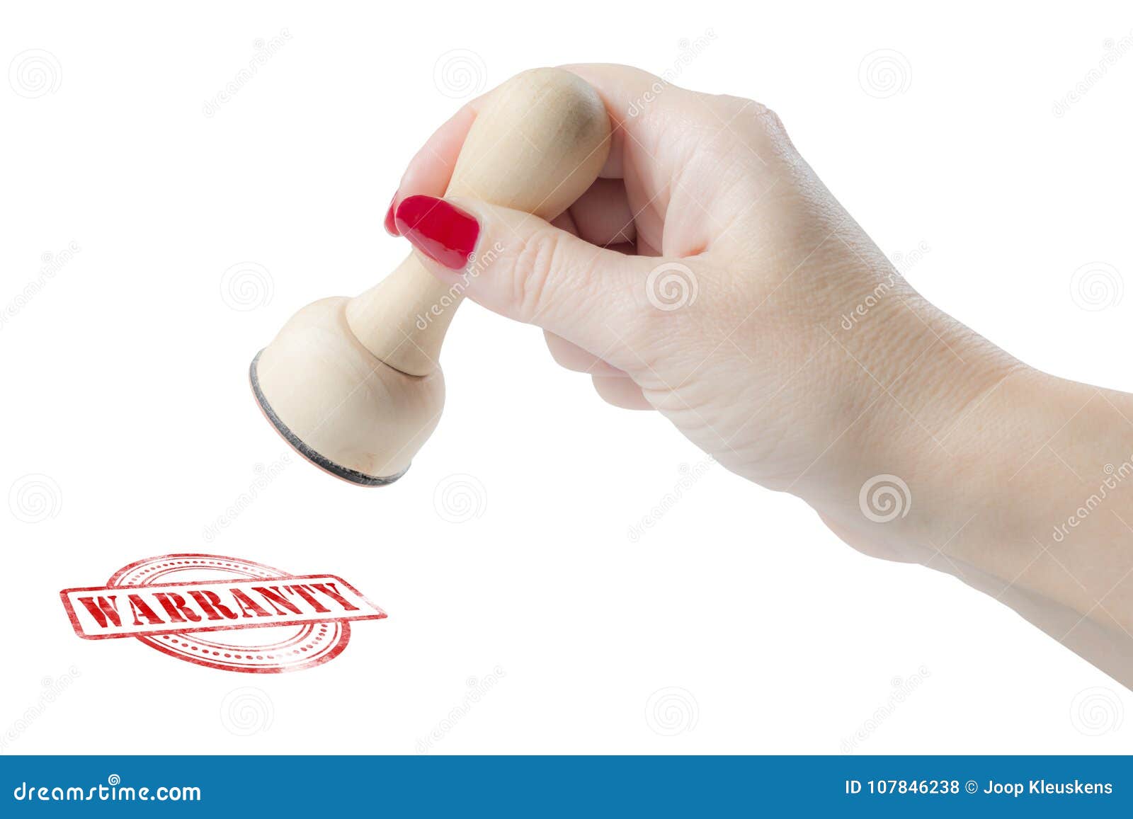 hand holding a rubber stamp with the word warranty