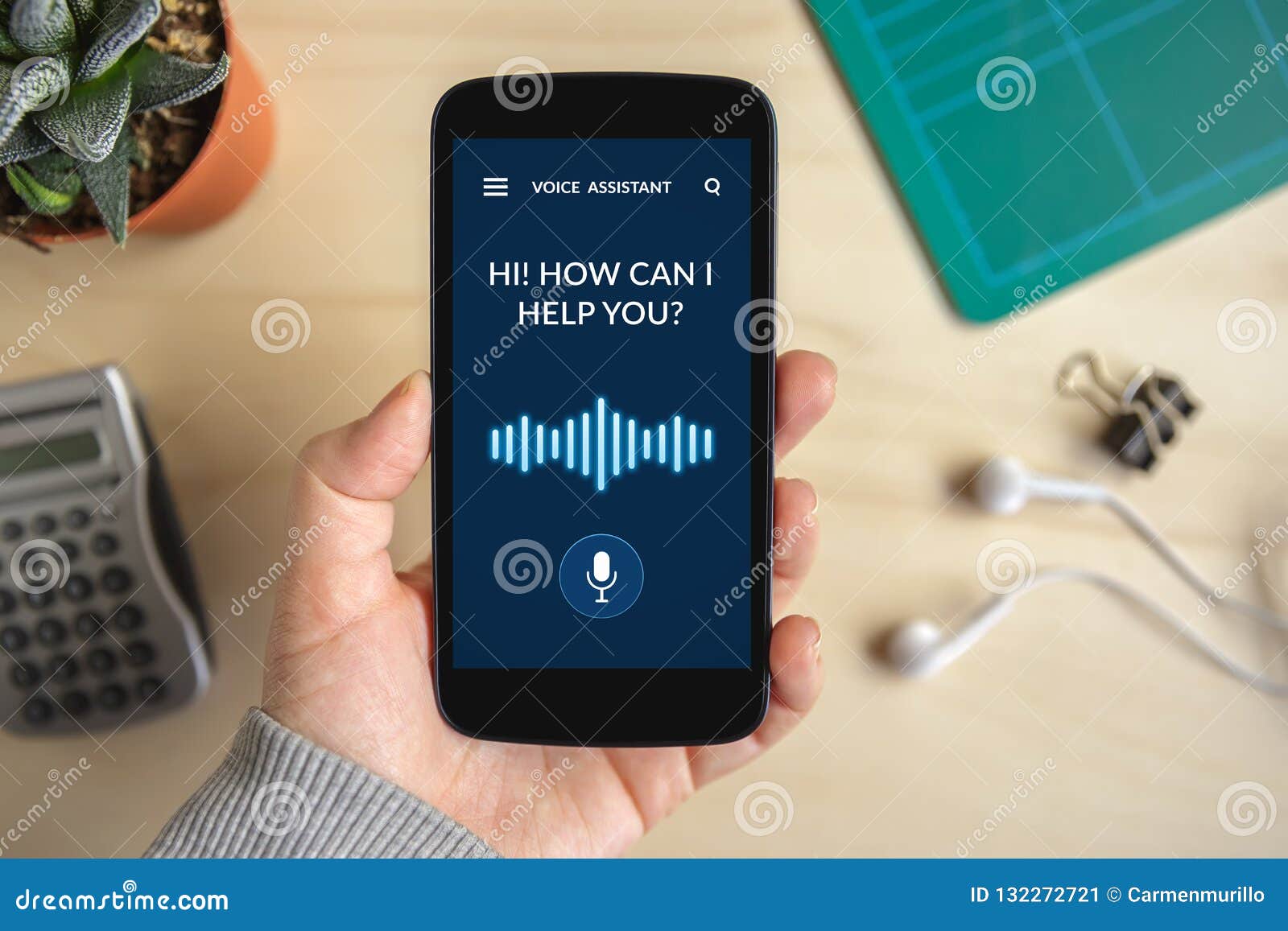 hand holding smart phone with voice assistant concept on screen