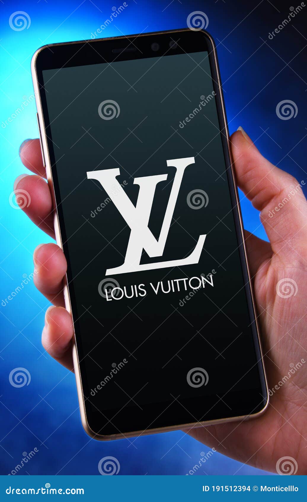 Hand Holding Smartphone Displaying Logo of Louis Vuitton Editorial