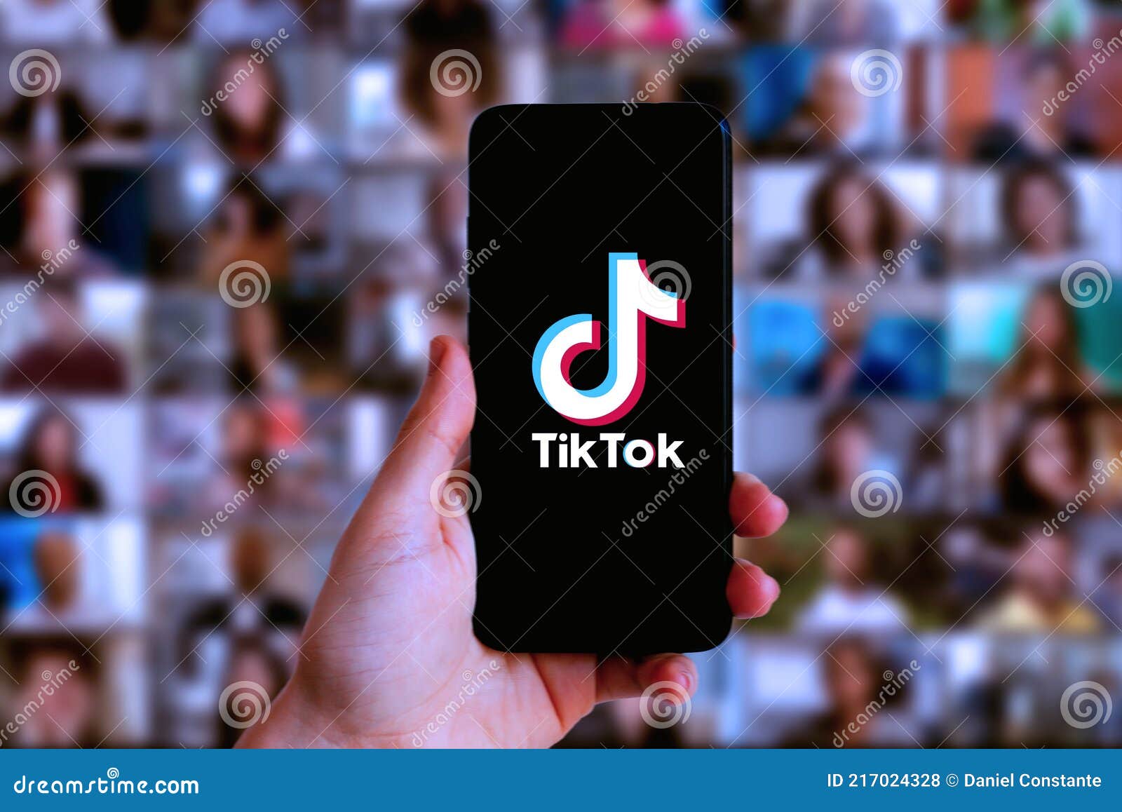 Hand Holding a Smartphone with TIK TOK Logo Editorial Stock Photo