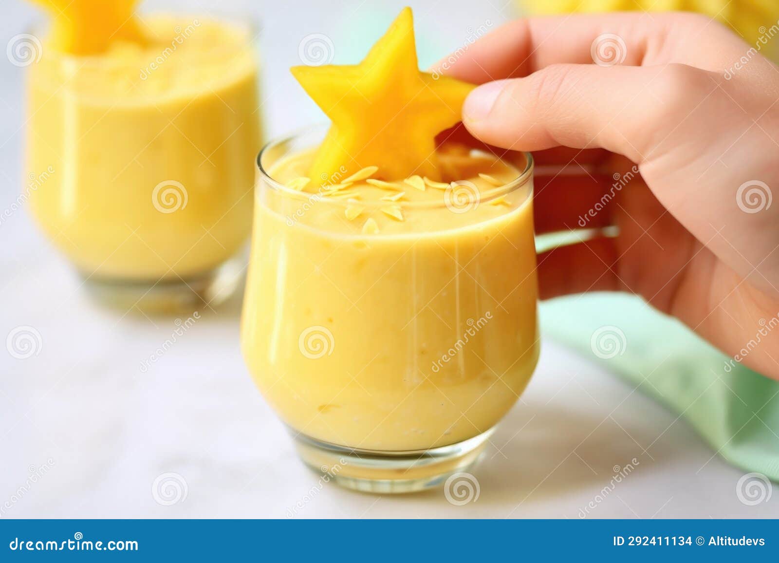 Hand Holding Starfruit Slice Over Tropical Flaxseed Smoothie Stock